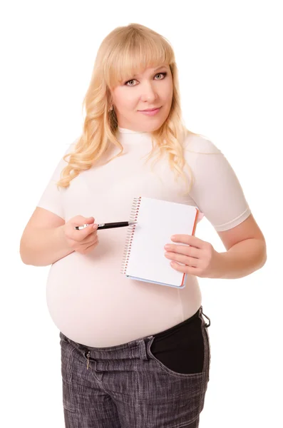 Έγκυος γυναίκα δείχνει ένα σημειωματάριο και στυλό — Φωτογραφία Αρχείου