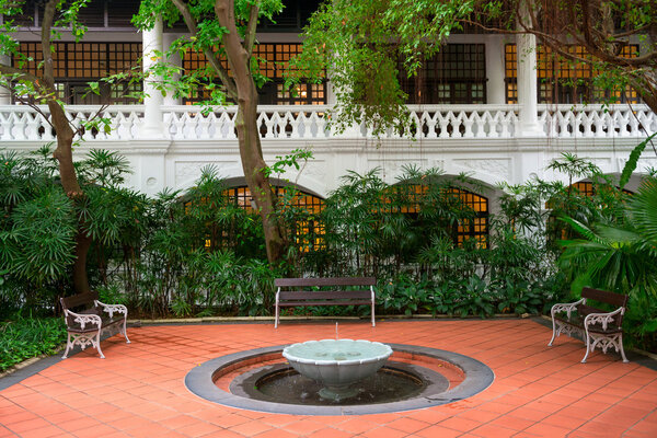 Small fountain in a garden with benches