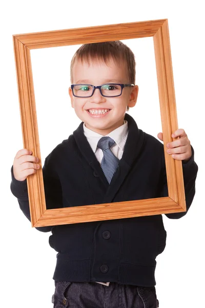 Sorrindo menino inteligente em moldura de madeira — Fotografia de Stock