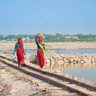 Indian women in sari on railway clipart