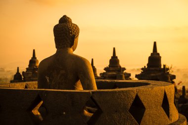 Buddha in Borobudur Temple at sunrise. Indonesia. clipart