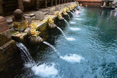Balinese holy springs in Tirta Empul temple clipart