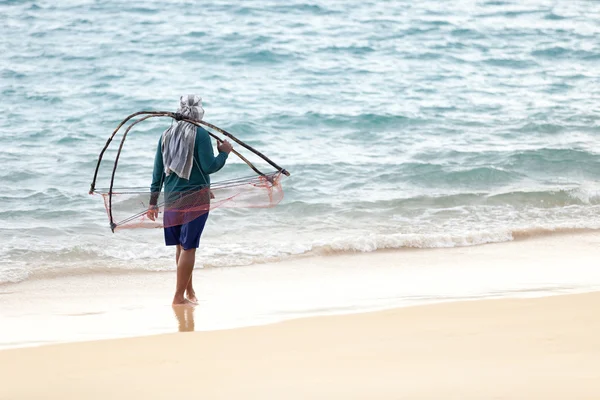 Man with net on sand coast, Thailand — Stock Photo, Image