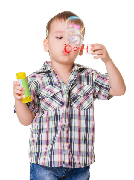 Boy blowing soap bubbles on white — Stock Photo, Image