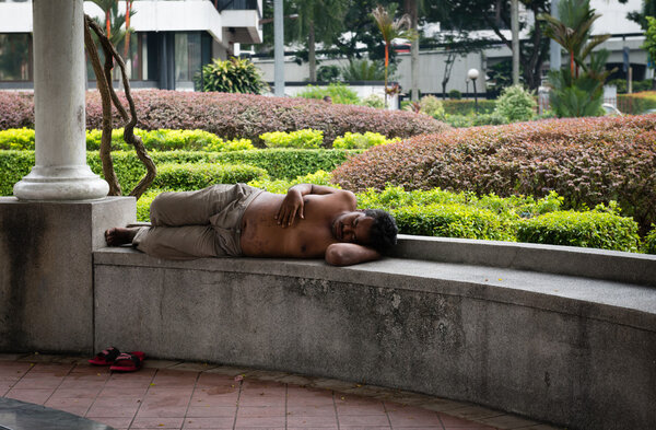Homeless men sleeping in a park