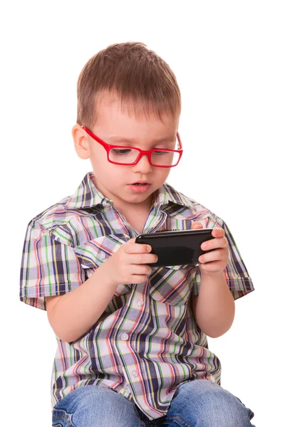 Clever kid is playing with smart cell phone — Stock Photo, Image