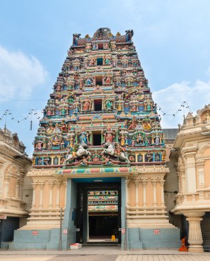 Entrance in a temple with Hindu Gods on gopuram clipart