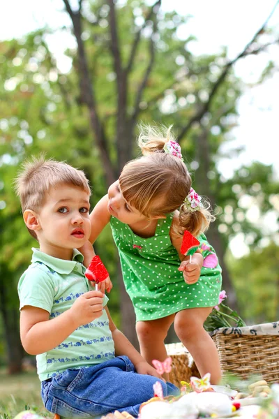 Caucasian little boy and girl eating sweets — Stock Photo, Image