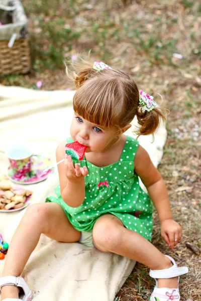 Caucasian little girl eating sweets — Stock Photo, Image