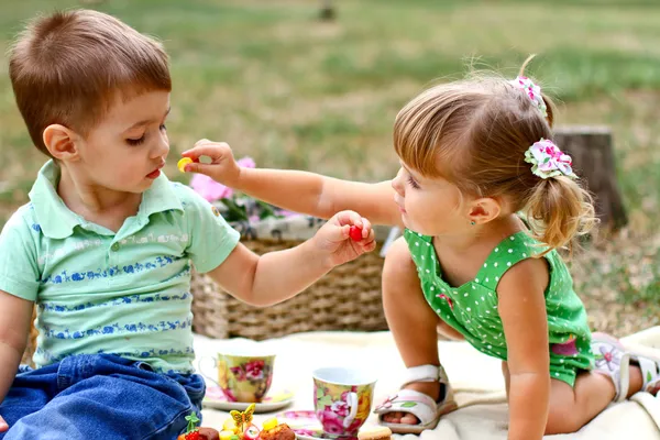 Kaukasische kleine jongen en meisje eten snoep Stockfoto