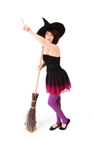 Halloween witch with a broom and pointing finger up isolated ove — Stock Photo, Image