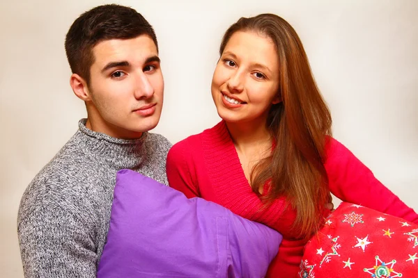 Sorrindo menino e menina com almofadas de Natal isolado em branco ba — Fotografia de Stock