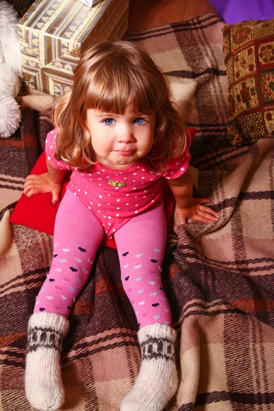 Cozy little girl with a blanket and gifts — Stock Photo, Image