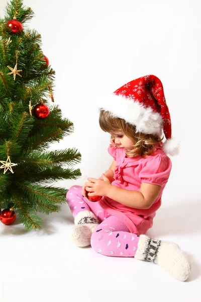 Sweet baby and a New Year or Christmas tree — Stock Photo, Image