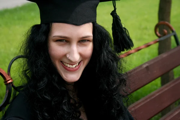 Beyaz öğrenci bankta oturan gülümsüyor