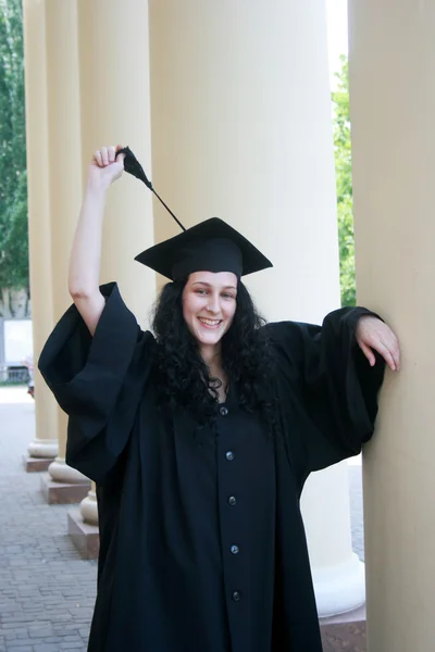 Young student in gown near the university — Stock Photo, Image