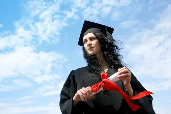 Happy graduate student in cloak with diploma — Stock Photo, Image