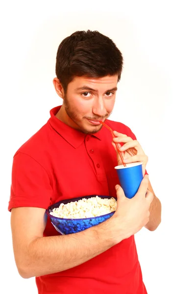 Smiling boy holding popcorn and drinking from cup isolated on wh — Stock Photo, Image