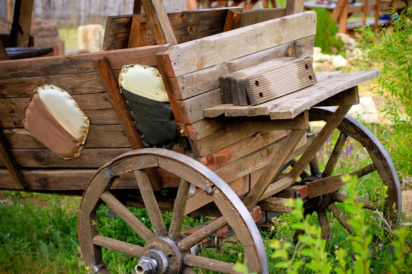 Wooden cart on grass outdoors — Stock Photo, Image