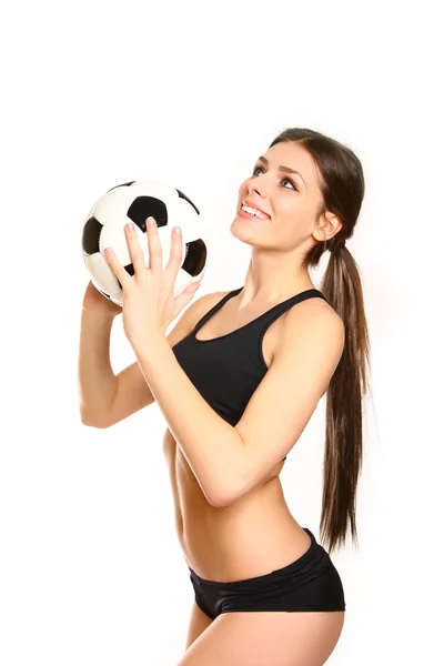 Menina atlética posando com uma bola de futebol em um fundo branco — Fotografia de Stock