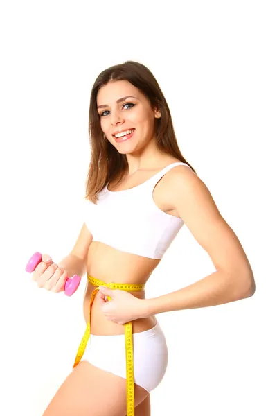 Young fitness woman with measuring tape and dumbbells Royalty Free Stock Photos