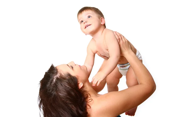 Young mother lifts her baby up on a white background — Stock Photo, Image