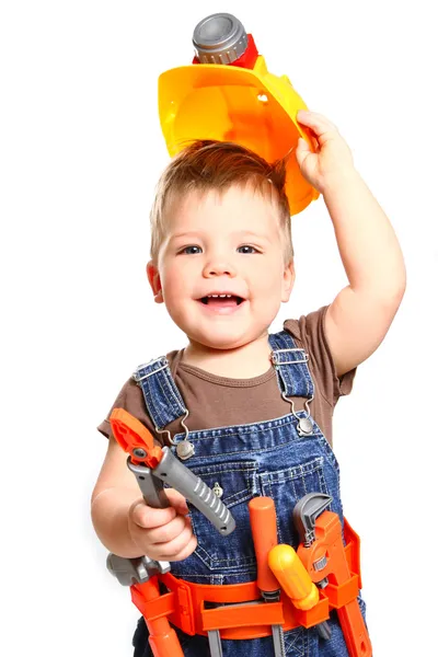 Gelukkig kleine jongen in een oranje helm en hulpprogramma's op een witte backgr Stockfoto