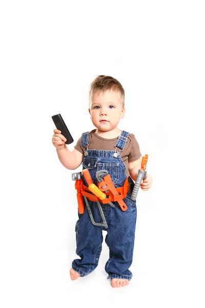 Маленький хлопчик з інструментами та мобільним телефоном на білому тлі Стокова Картинка