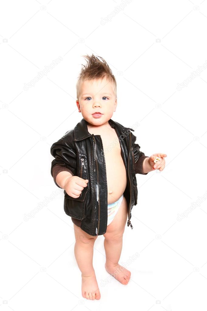 Funny little boy in a leather jacket and a diaper on a white bac