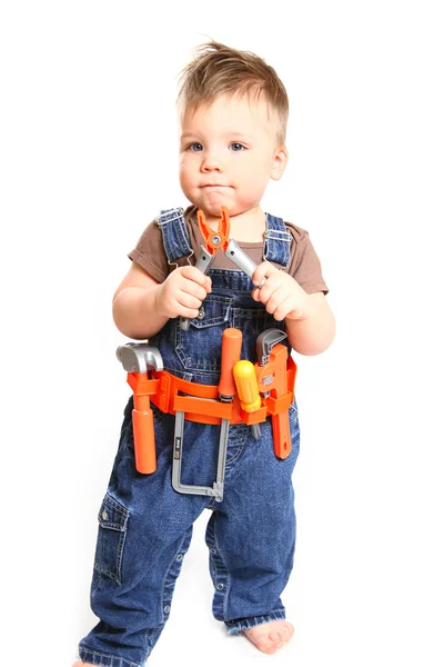 Menino com ferramentas em um fundo branco — Fotografia de Stock