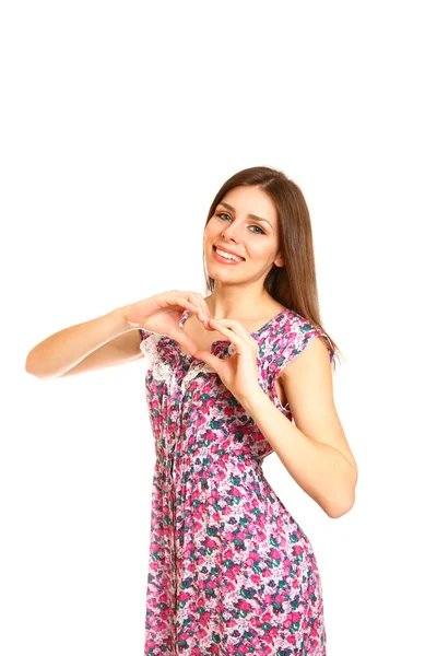 Vacker ung kvinna att göra en kärlek hjärta med händerna på en vit — Stockfoto