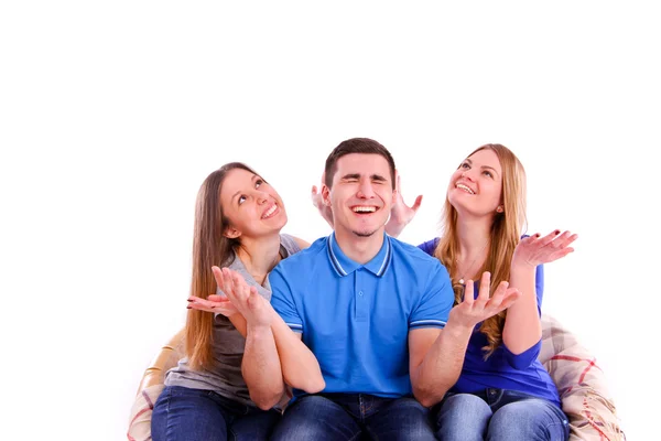 Friends sitting on a sofa and watching television — Stock Photo, Image