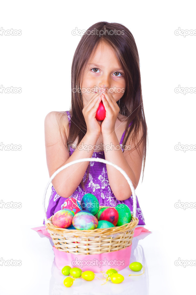 Little girl with basket full of colorful eggs