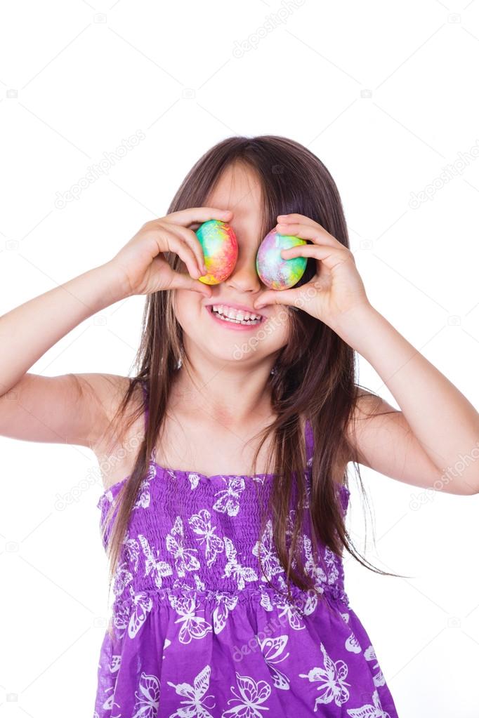 Cute girl keeping two decorated easter eggs