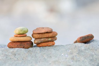 Stack of round smooth stones on a seashore clipart