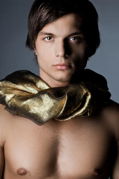 Young man in golden scarf — Stock Photo, Image