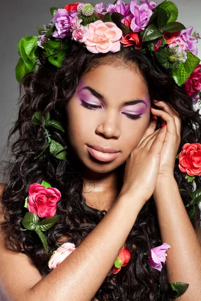 Elegant mulatto girl with circlet of flowers — Stock Photo, Image