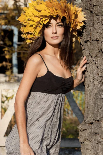 Woman with yellow leaves in autumn — Stock Photo, Image