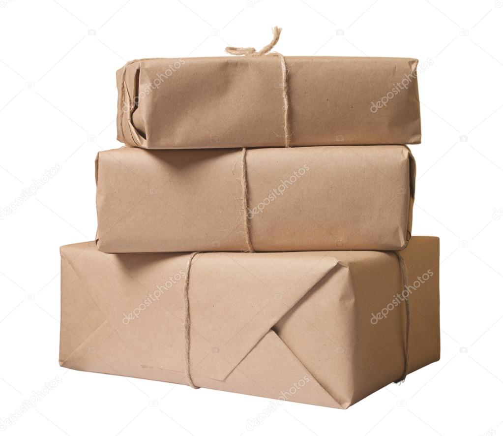 Parcel wrapped with brown paper tied with rope isolated on white background