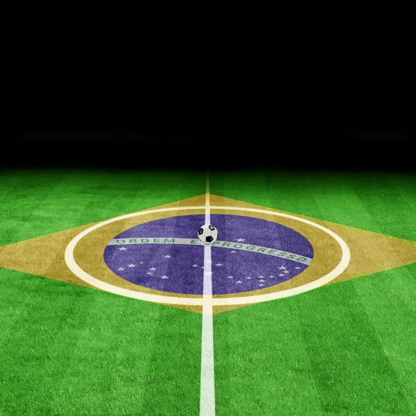 Brazilian flag on a soccer field — Stock Photo, Image