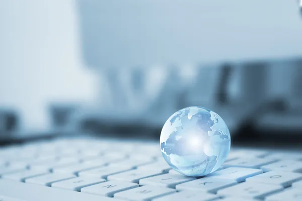 Transparent globe on a keyboard — Stock Photo, Image