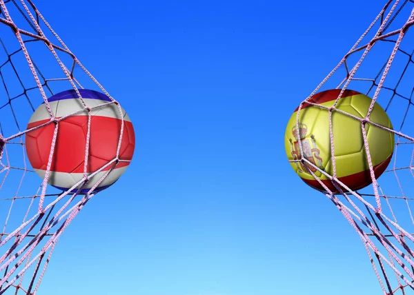 Two soccer balls in flags  Costa rica and Spain, in a net