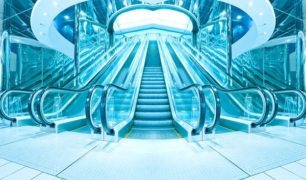 Business hall with blue vanishing escalators — Stock Photo, Image