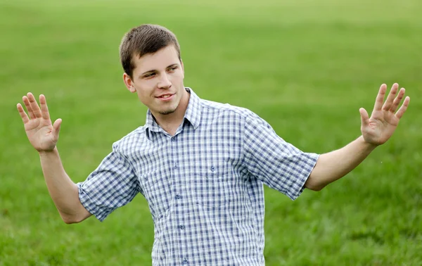 Active smiling young man enjoying in nature — Stock Photo, Image