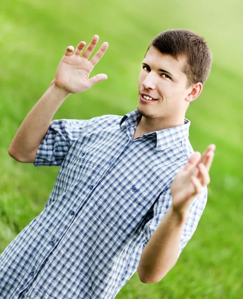 Active smiling young man enjoying in nature — Stock Photo, Image