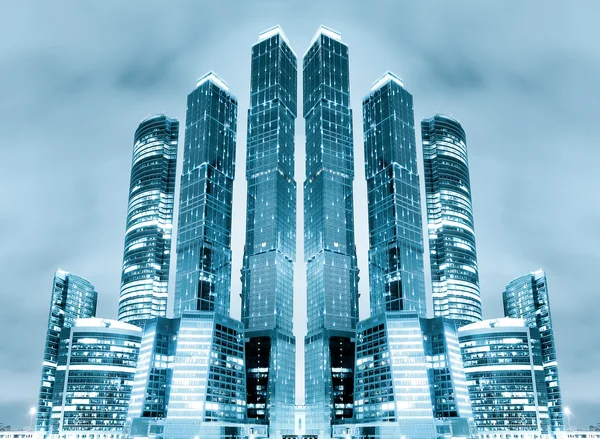 Perspective view to glass high-rise building skyscrapers at nigh — Stock Photo, Image