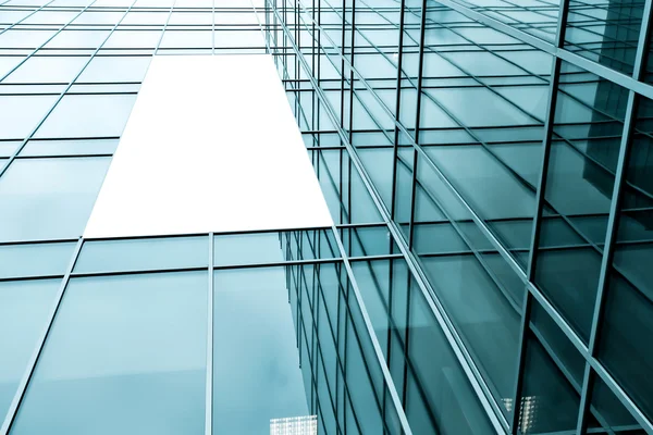 Blue glass wall with blank placard of skyscraper — Stock Photo, Image