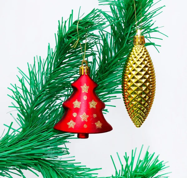 Branch of Christmas tree with colorful bauble hanging — Stock Photo, Image