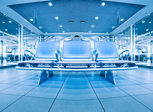 Contemporary blue lounge with seats in the airport Stock Photo