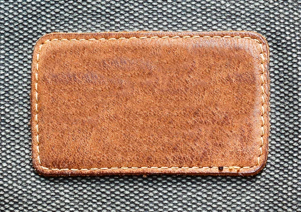 Leather label over denim texture — Stock Photo, Image